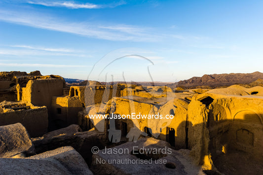 Looking across the rooftops of crumbling handmade brick ruins of an ancient abandoned village in the desert. Kharanagh, Yazd, Yazd Province, Islamic Republic of Iran.