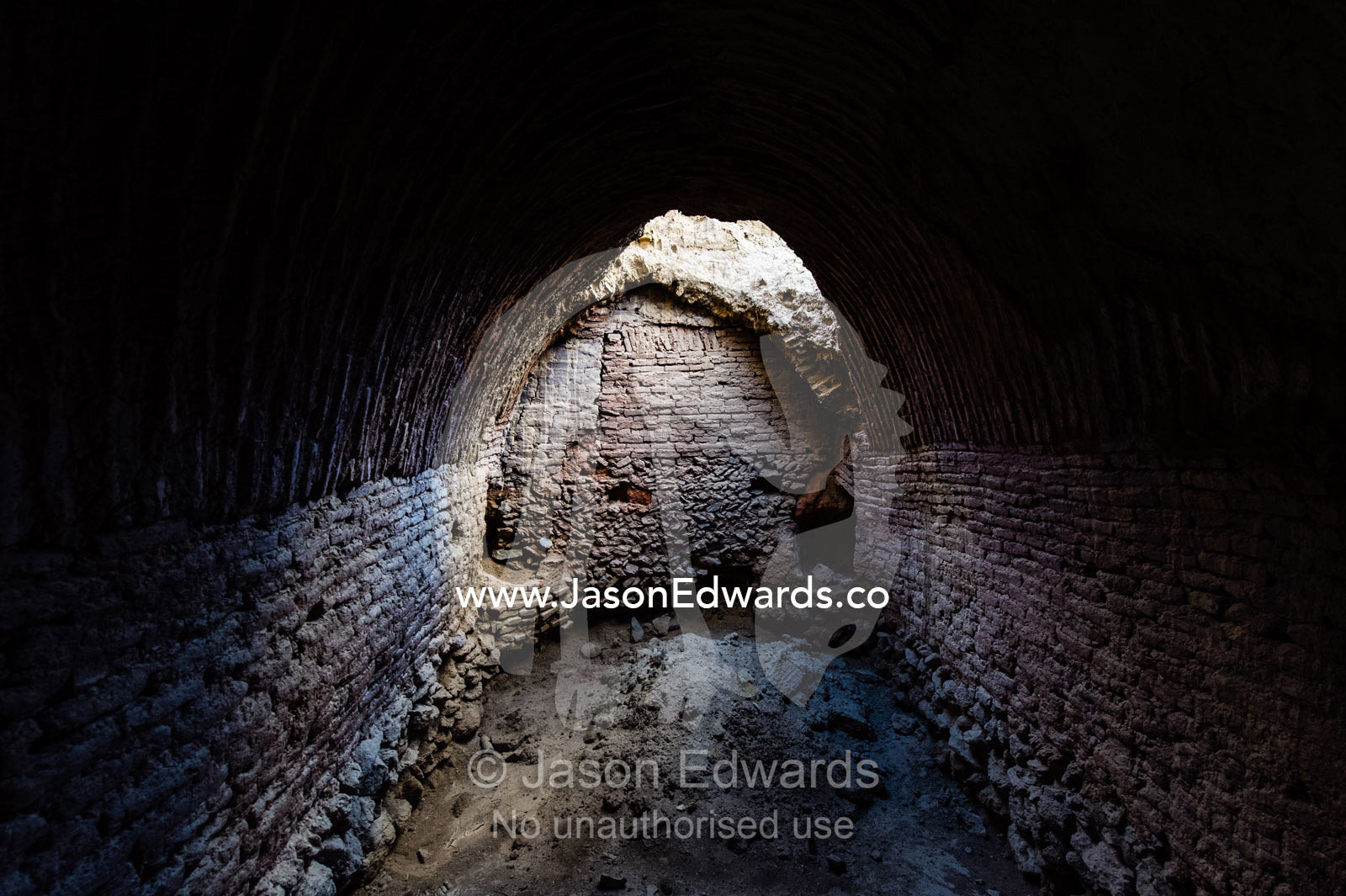 A vaulted room of crumbling handmade brick ruins of an ancient abandoned village in the desert. Kharanagh, Yazd, Yazd Province, Islamic Republic of Iran.