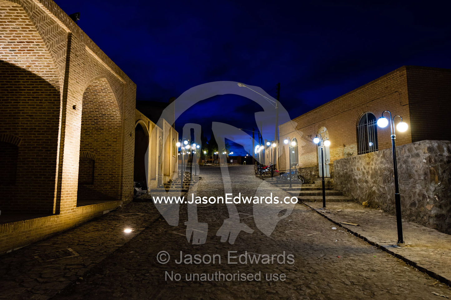 Streetlights along a paved street in an ancient village. Kharanagh, Yazd, Yazd Province, Islamic Republic of Iran.