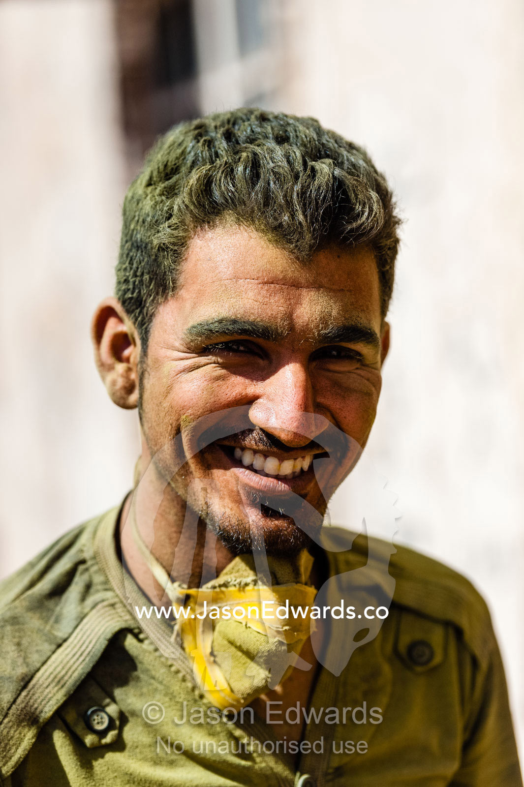 A smiling labourer takes a rest break from working in a henna mill. Yazd, Yazd Province, Islamic Republic of Iran.