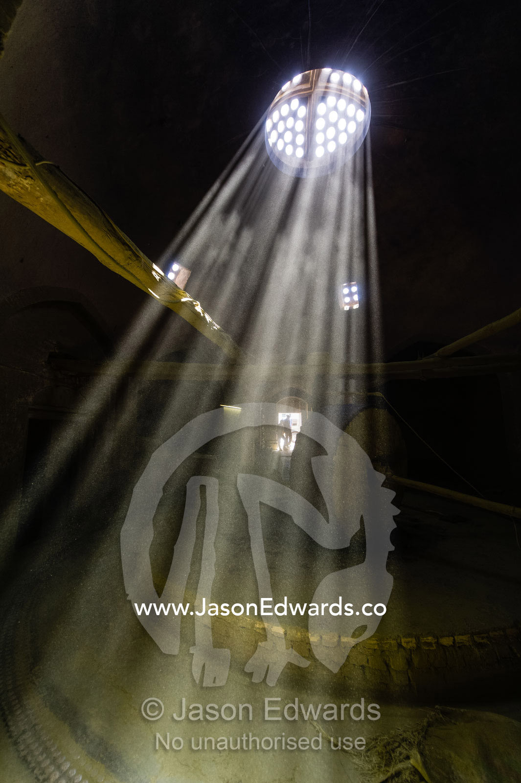 Sunrays passing through a skylight into the dusty air of a henna mill. Yazd, Yazd Province, Islamic Republic of Iran.