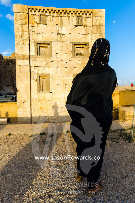 A woman photographs one of the four tombs belonging to Achaemenid kings carved from the rock face at the Necropolis. Tombs of the Kings, Naqsh-e Rustam, Fars Province, Islamic Republic of Iran.