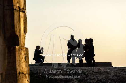 Iranian tourists make a family photograph at the four tombs belonging to Achaemenid kings carved from the rock face at the archeological site of Naqsh-e Rustam also known as the Necropolis. Tombs of the Kings, Naqsh-e Rustam, Fars Province, Islamic Republic of Iran.