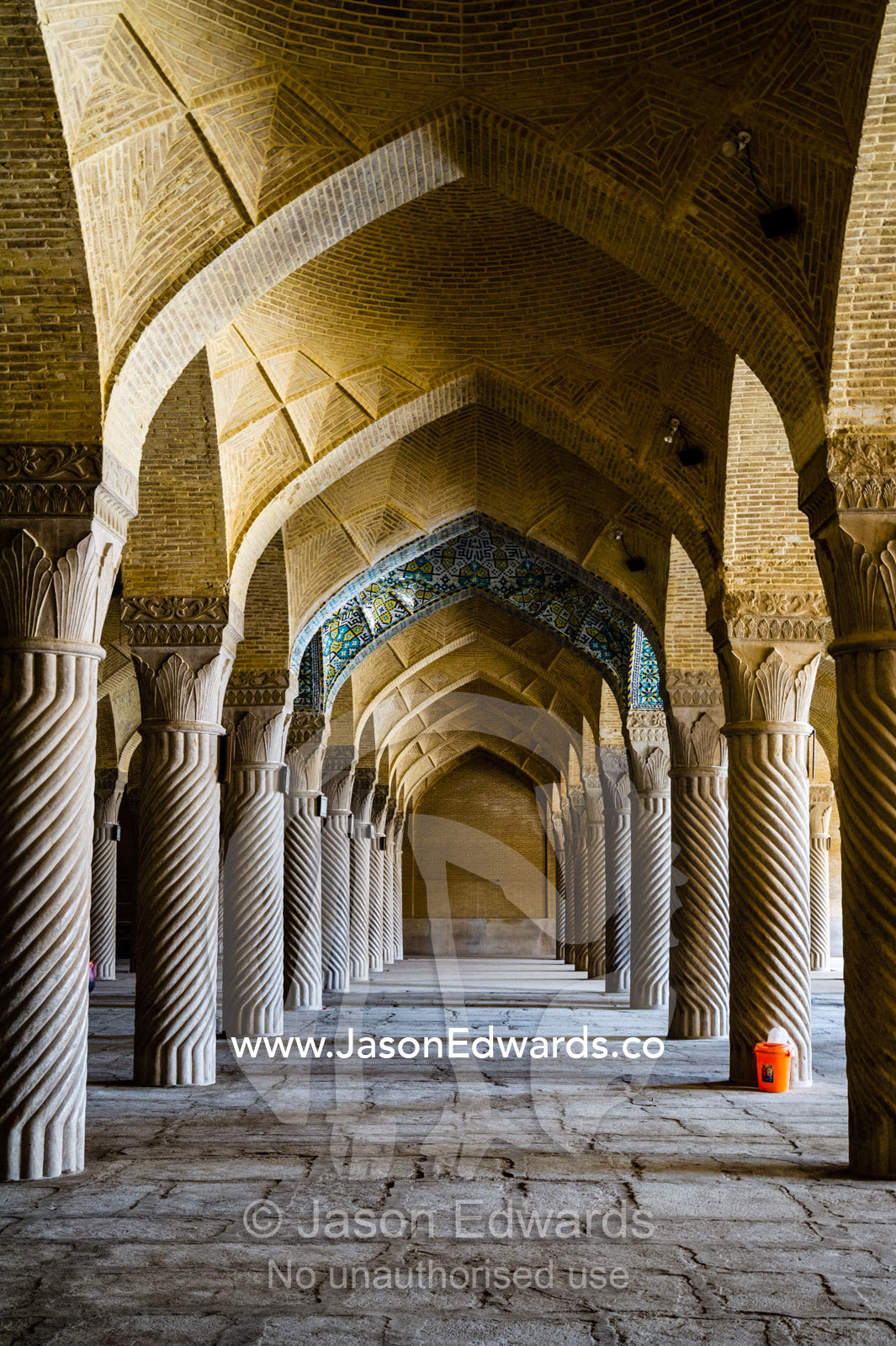 Vaulted ceilings supported by stone columns covered in coiling rope patterns in the Vakil Mosque. Vakil Mosque, Shiraz, Fars Province, Islamic Republic of Iran.