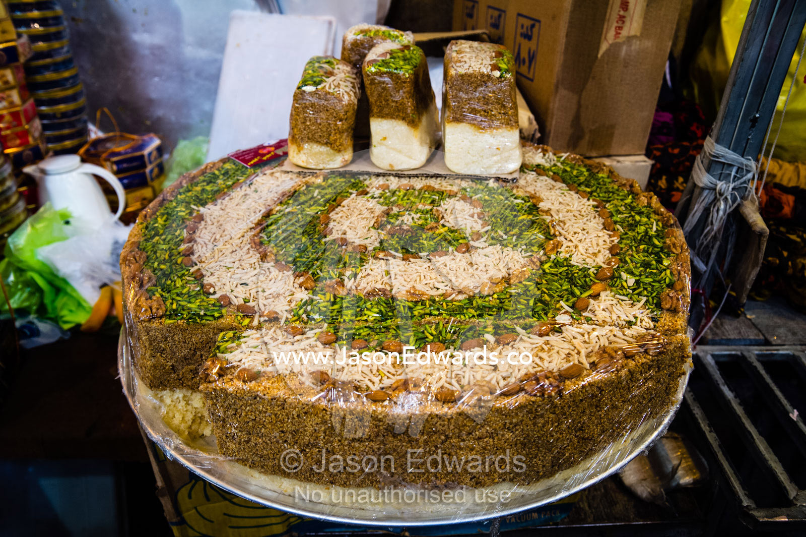 A large sesame pudding for sale in a bazaar market. Shiraz, Fars Province, Islamic Republic of Iran.
