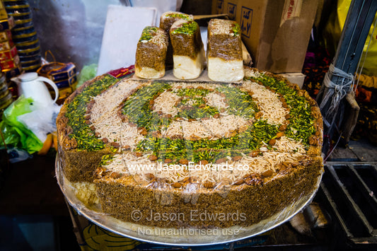 A large sesame pudding for sale in a bazaar market. Shiraz, Fars Province, Islamic Republic of Iran.