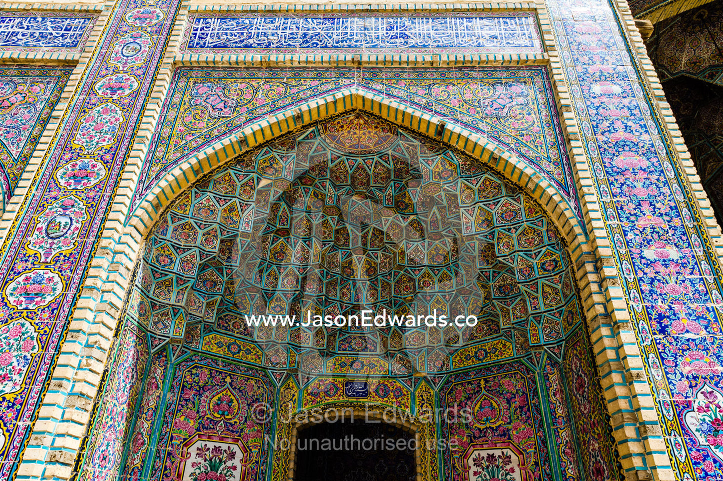 The intricate tiled muqarnas on the vaulted surface of the iwan of Nasir ol Molk Mosque. Nasir ol Molk Mosque, Shiraz, Fars Province, Islamic Republic of Iran.