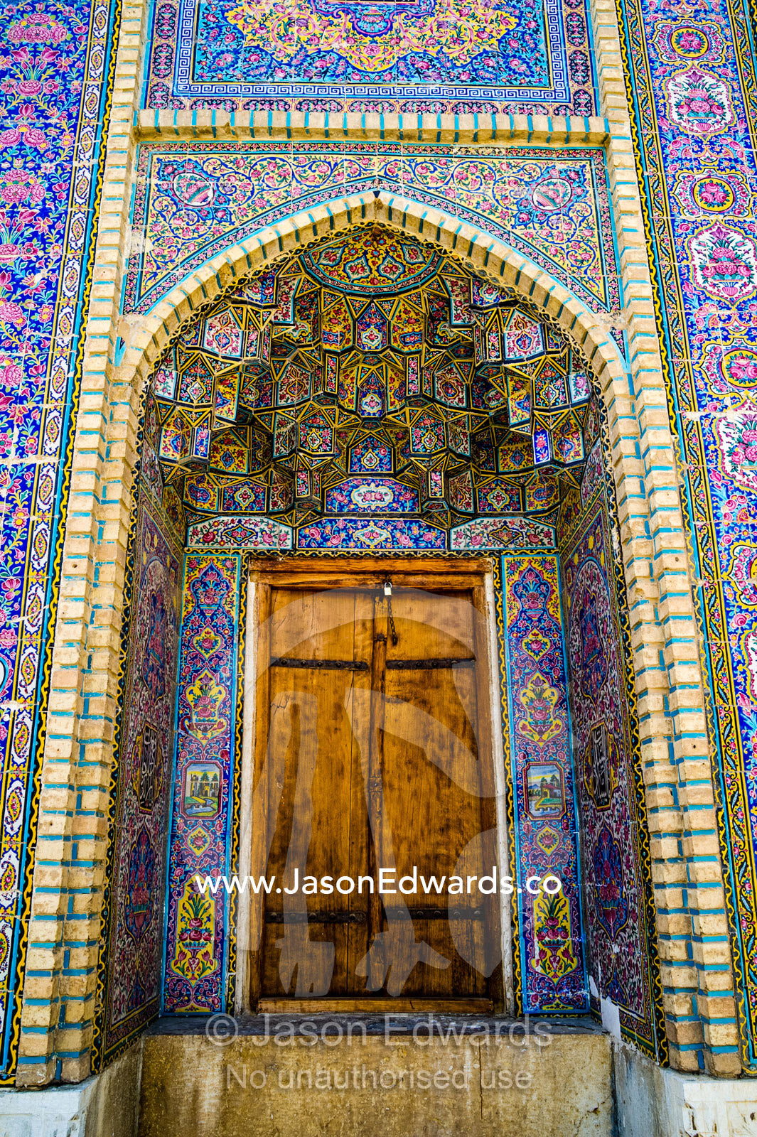 The intricate tiled muqarnas on the vaulted surface of the iwan of Nasir ol Molk Mosque. Nasir ol Molk Mosque, Shiraz, Fars Province, Islamic Republic of Iran.