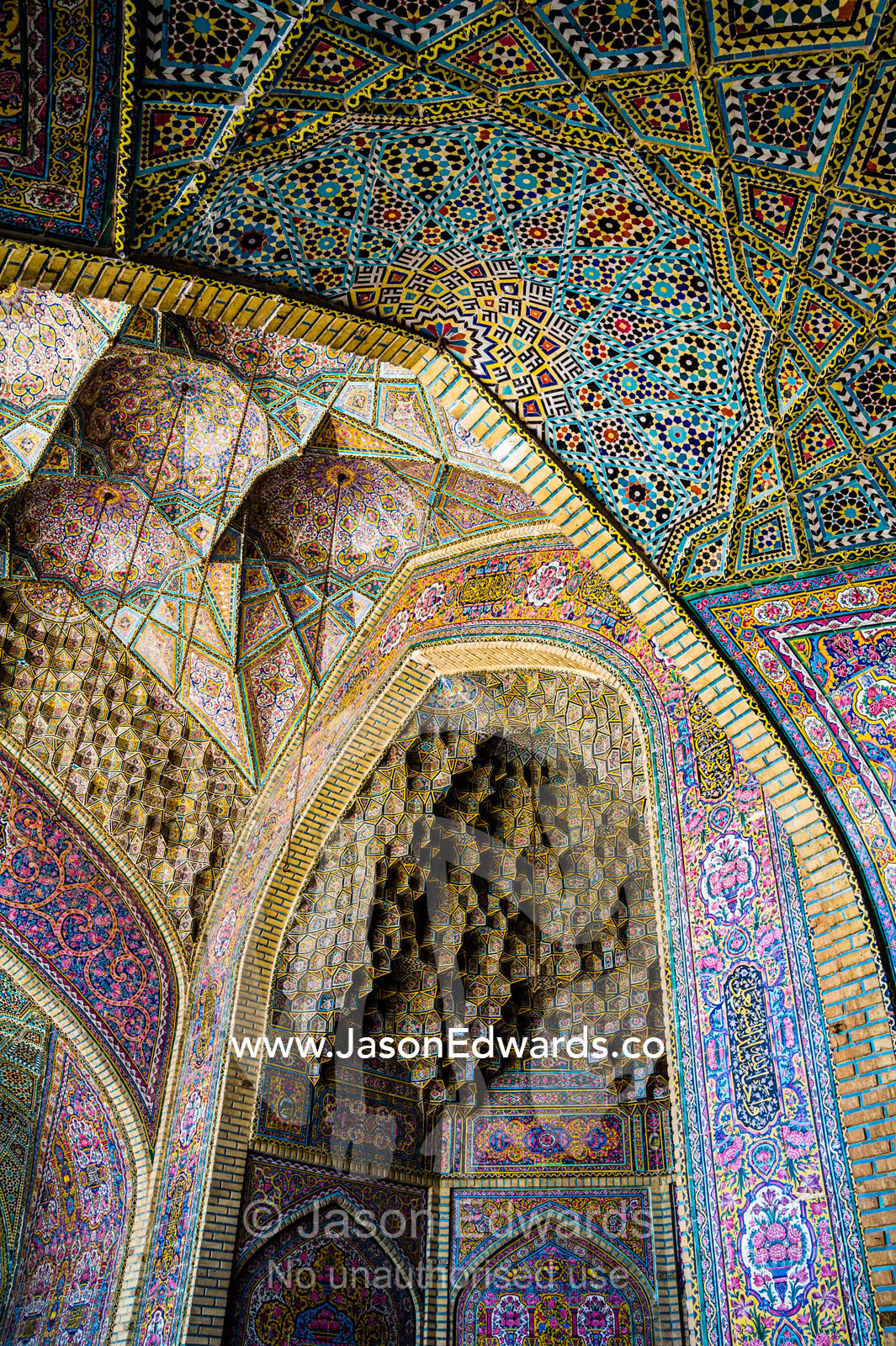 The intricate tiled muqarnas on the vaulted surface of the iwan of Nasir ol Molk Mosque. Nasir ol Molk Mosque, Shiraz, Fars Province, Islamic Republic of Iran.