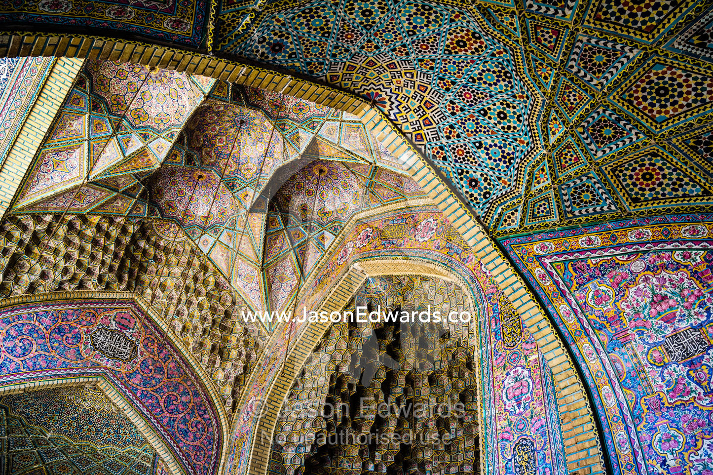 The intricate tiled muqarnas on the vaulted surface of the iwan of Nasir ol Molk Mosque. Nasir ol Molk Mosque, Shiraz, Fars Province, Islamic Republic of Iran.