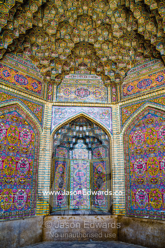 The intricate tiled muqarnas on the vaulted surface of the iwan of Nasir ol Molk Mosque. Nasir ol Molk Mosque, Shiraz, Fars Province, Islamic Republic of Iran.