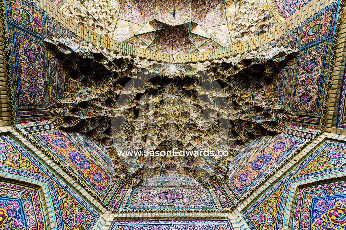 The intricate tiled muqarnas on the vaulted surface of the iwan of Nasir ol Molk Mosque. Nasir ol Molk Mosque, Shiraz, Fars Province, Islamic Republic of Iran.