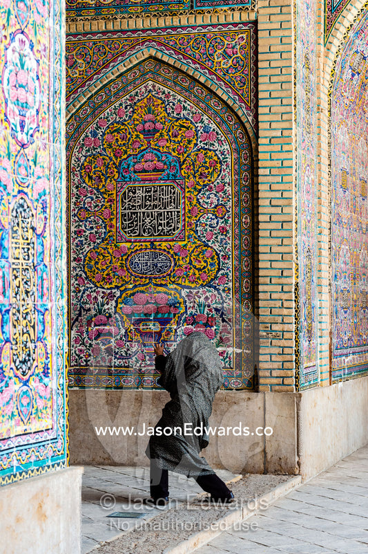 An Iranian tourist photographs the intricate tiled muqarnas on the vaulted surface of the iwan of Nasir ol Molk Mosque. Nasir ol Molk Mosque, Shiraz, Fars Province, Islamic Republic of Iran.