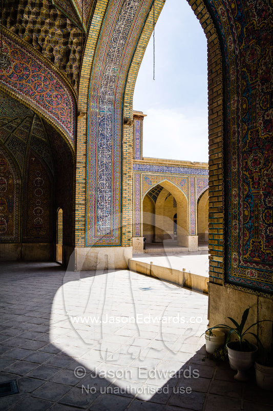 The tiled iwan leads to the courtyard of the Nasir ol Molk Mosque. Nasir ol Molk Mosque, Shiraz, Fars Province, Islamic Republic of Iran.
