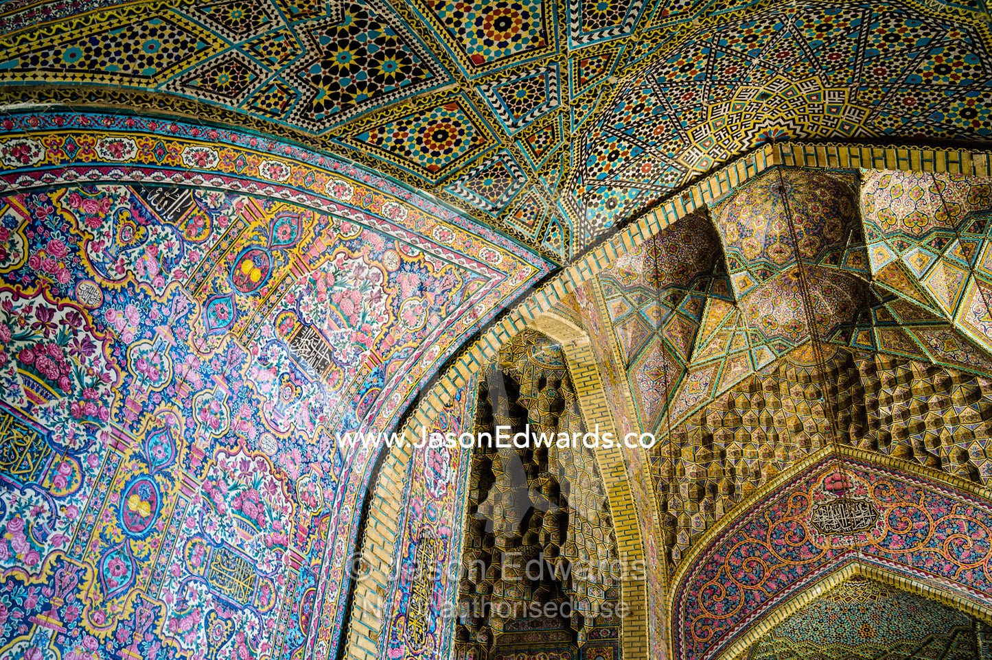 The intricate tiled muqarnas on the vaulted surface of the iwan of Nasir ol Molk Mosque. Nasir ol Molk Mosque, Shiraz, Fars Province, Islamic Republic of Iran.