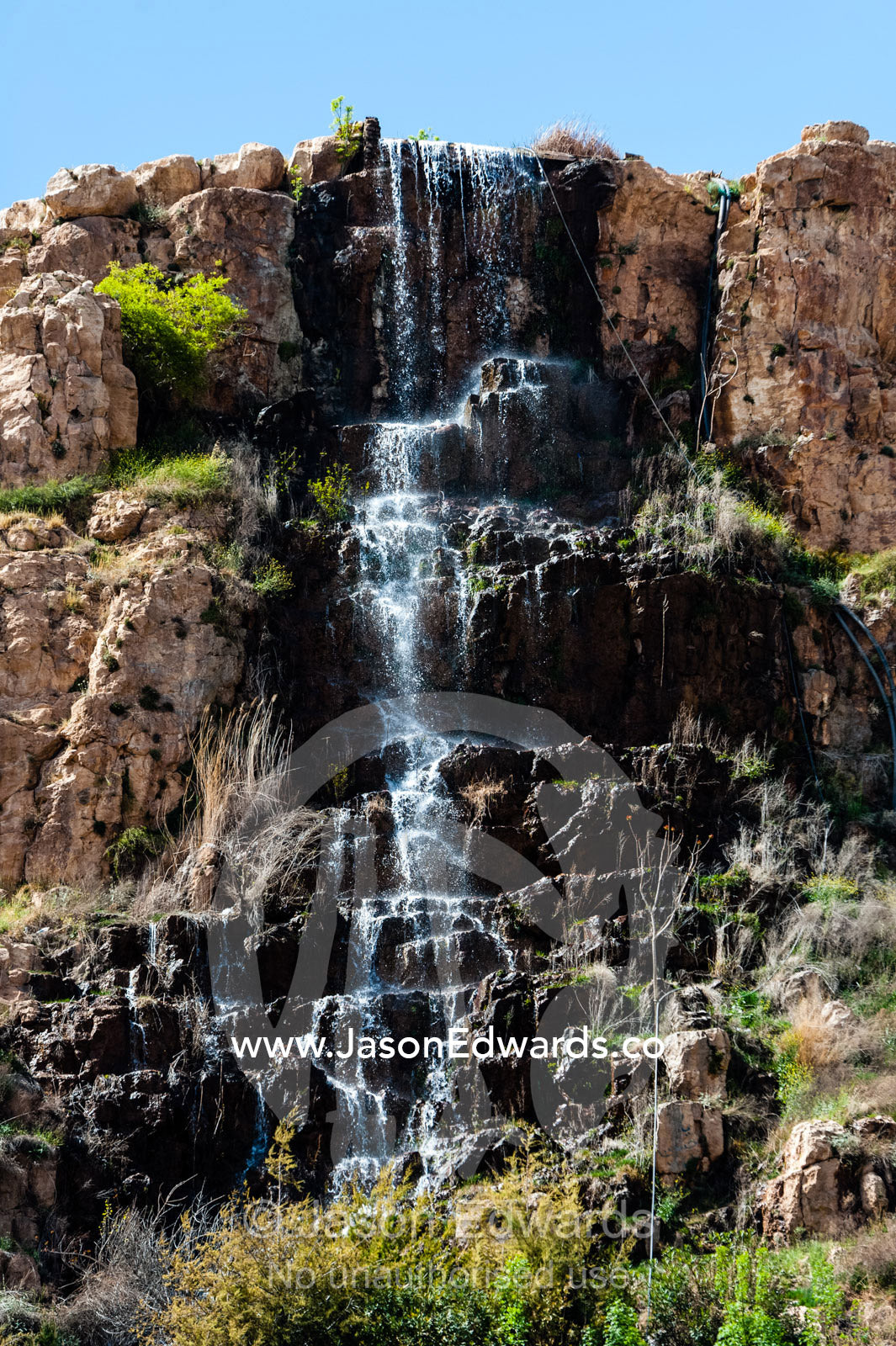 A small stream cascades down a cliff in a waterfall. Shiraz, Fars Province, Islamic Republic of Iran.