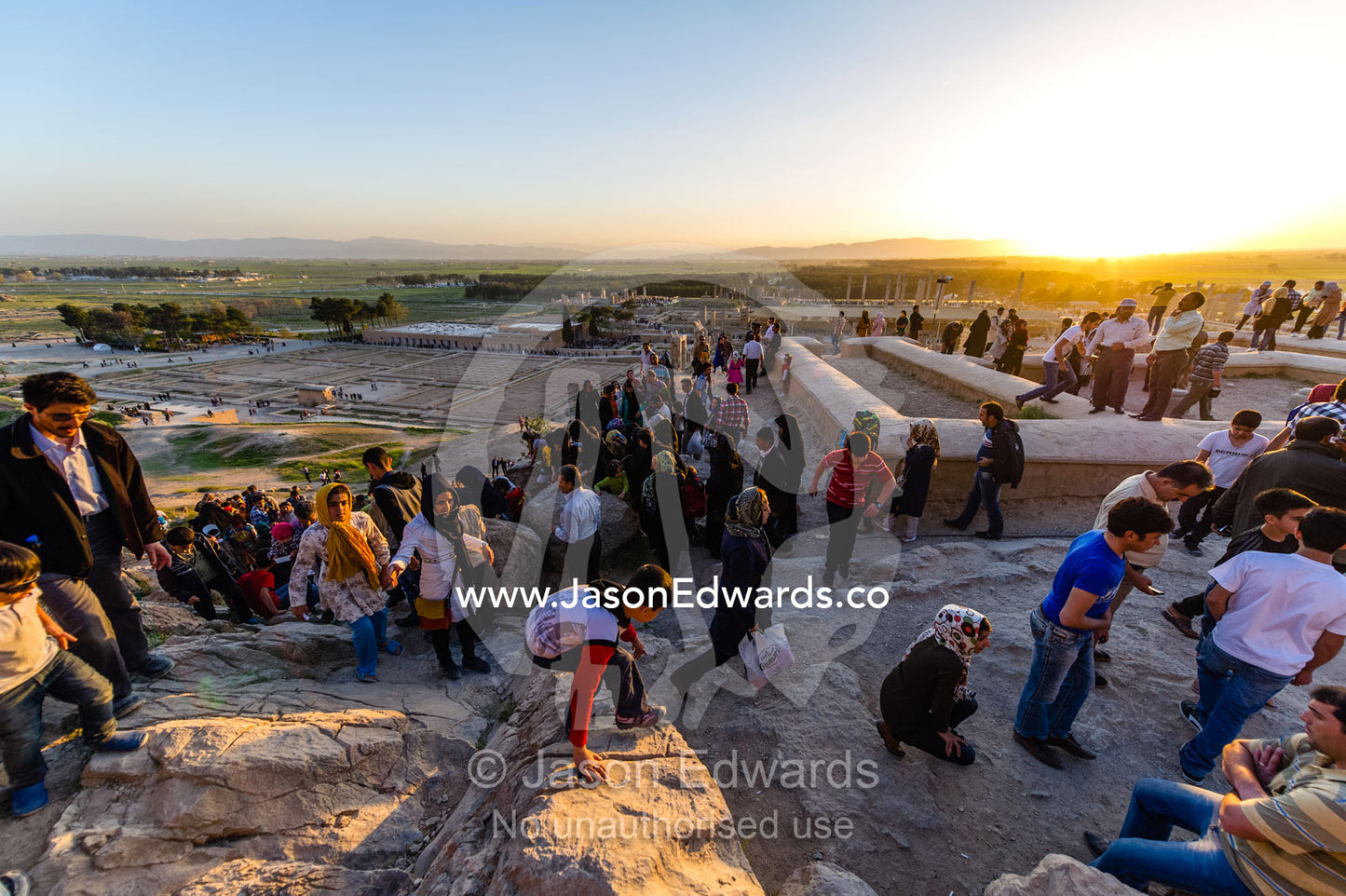 Iranian toursists exploring the ruins of Persepolis at sunset. Persepolis, Shiraz, Fars Province, Islamic Republic of Iran.