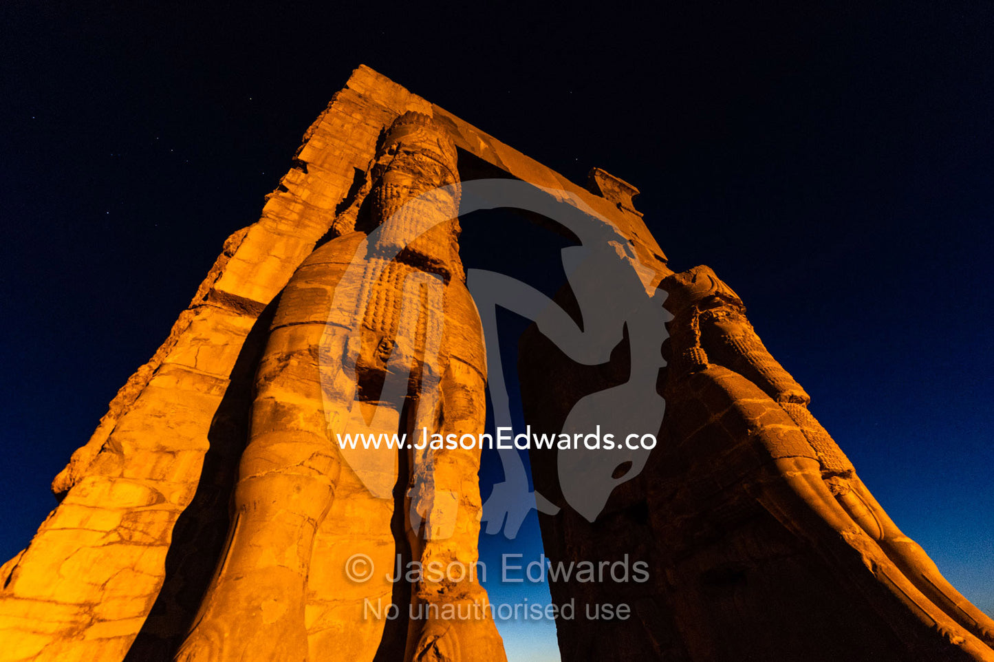 Towering protective gods known as Lamassu at the Gate of All Nations in Persepolis at sunset. Persepolis, Shiraz, Fars Province, Islamic Republic of Iran.
