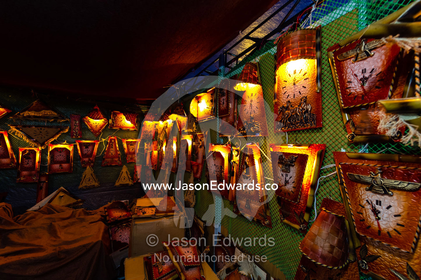 A stall at the ruins of Persepolis selling souvenier clocks. Persepolis, Shiraz, Fars Province, Islamic Republic of Iran.