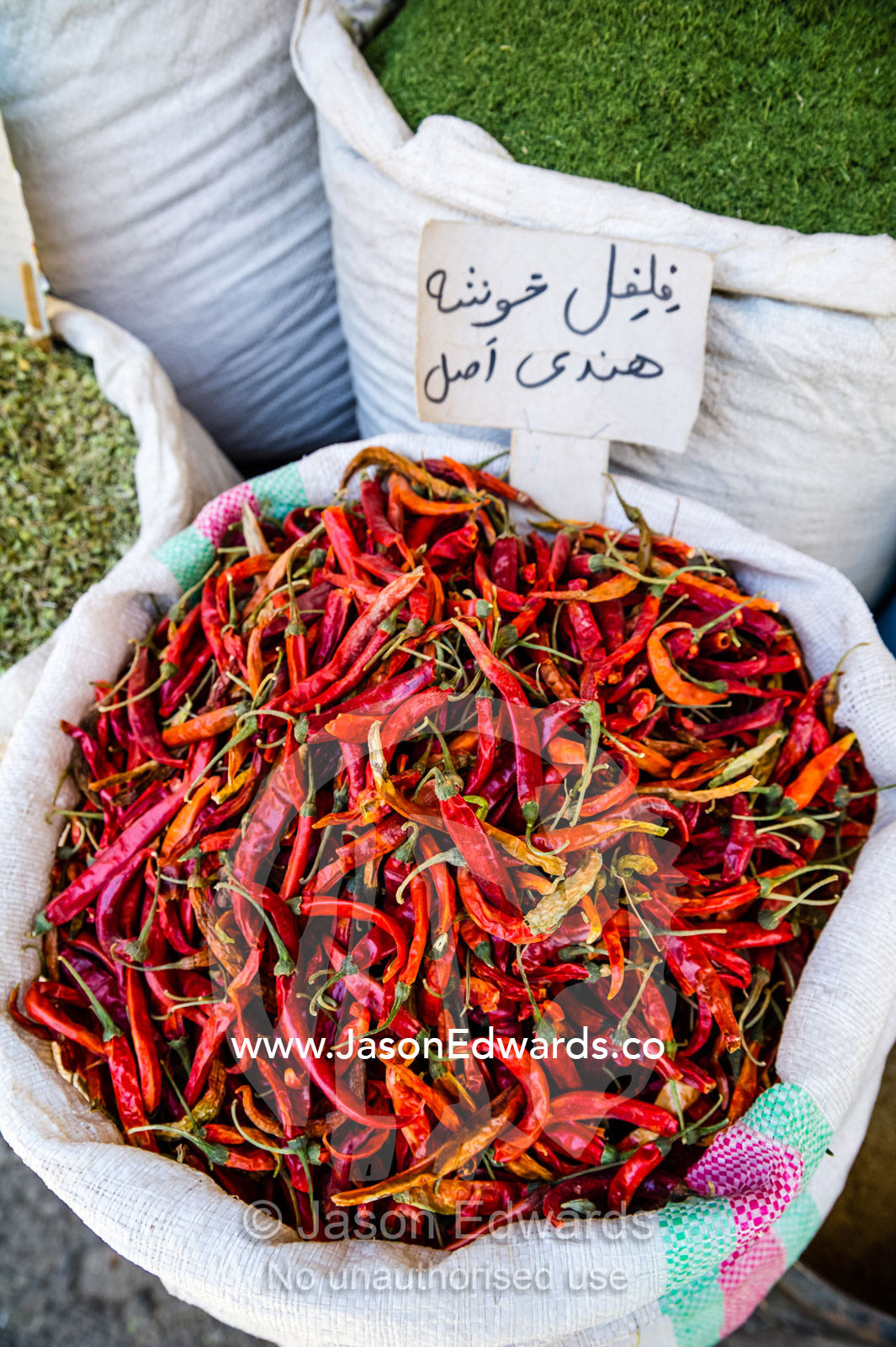 Bright red chilli for sale in a fresh food market. Shiraz, Fars Province, Islamic Republic of Iran.