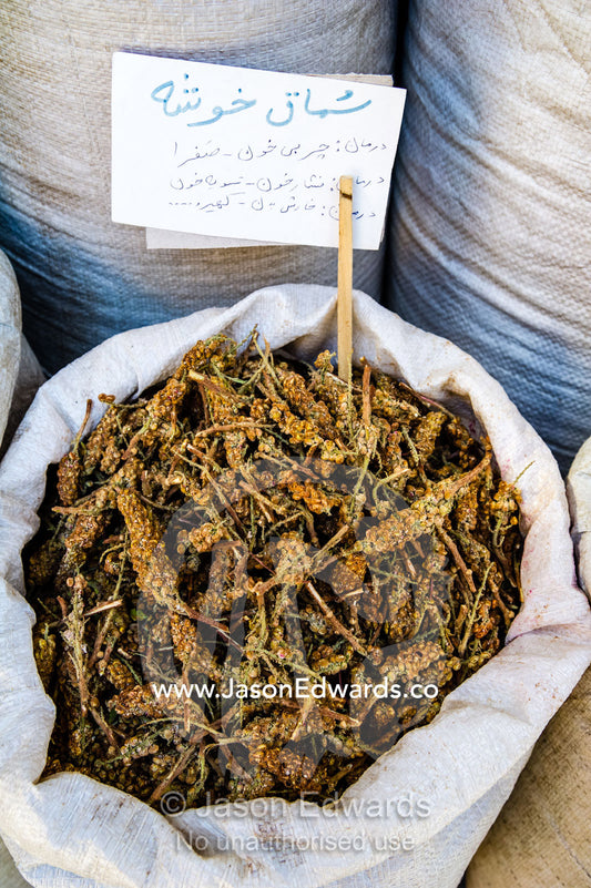Rhus coriaria also called sumac for cooking and in kebabs for sale in a fresh food market. Shiraz, Fars Province, Islamic Republic of Iran.
