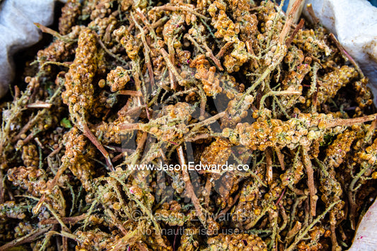 Rhus coriaria also called sumac for cooking and in kebabs for sale in a fresh food market. Shiraz, Fars Province, Islamic Republic of Iran.