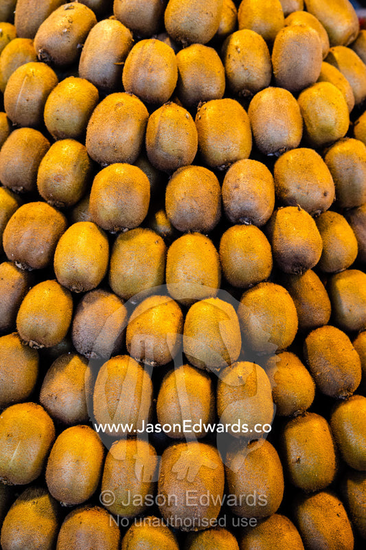 Rows of neatly stacked kiwi fruit for sale in a fresh food market. Shiraz, Fars Province, Islamic Republic of Iran.