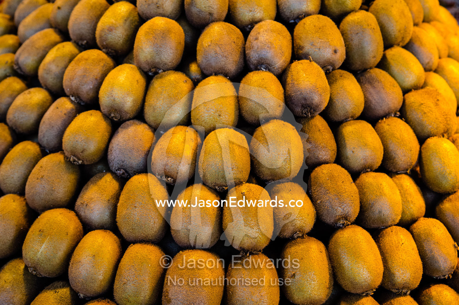 Rows of neatly stacked kiwi fruit for sale in a fresh food market. Shiraz, Fars Province, Islamic Republic of Iran.