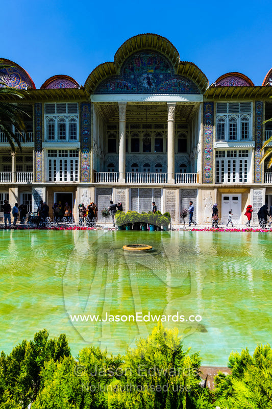 Palm trees line the facade of a large historical home overlooking a garden pond. Eram Garden, Shiraz, Fars Province, Islamic Republic of Iran.