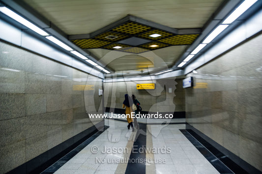 A commuter walks down a corridor in a railway subway system beneath Tehran. Tehran, Tehran Province, Islamic Republic of Iran.