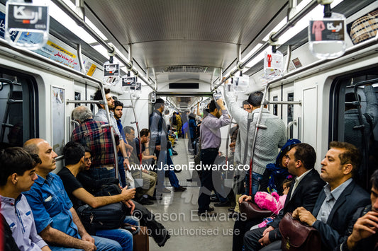 Commuters in a train carriage in a railway subway system beneath Tehran. Tehran, Tehran Province, Islamic Republic of Iran.