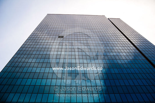 Clouds reflecting off the steel and glass facade of a banking office in Tehran. Tehran, Tehran Province, Islamic Republic of Iran.