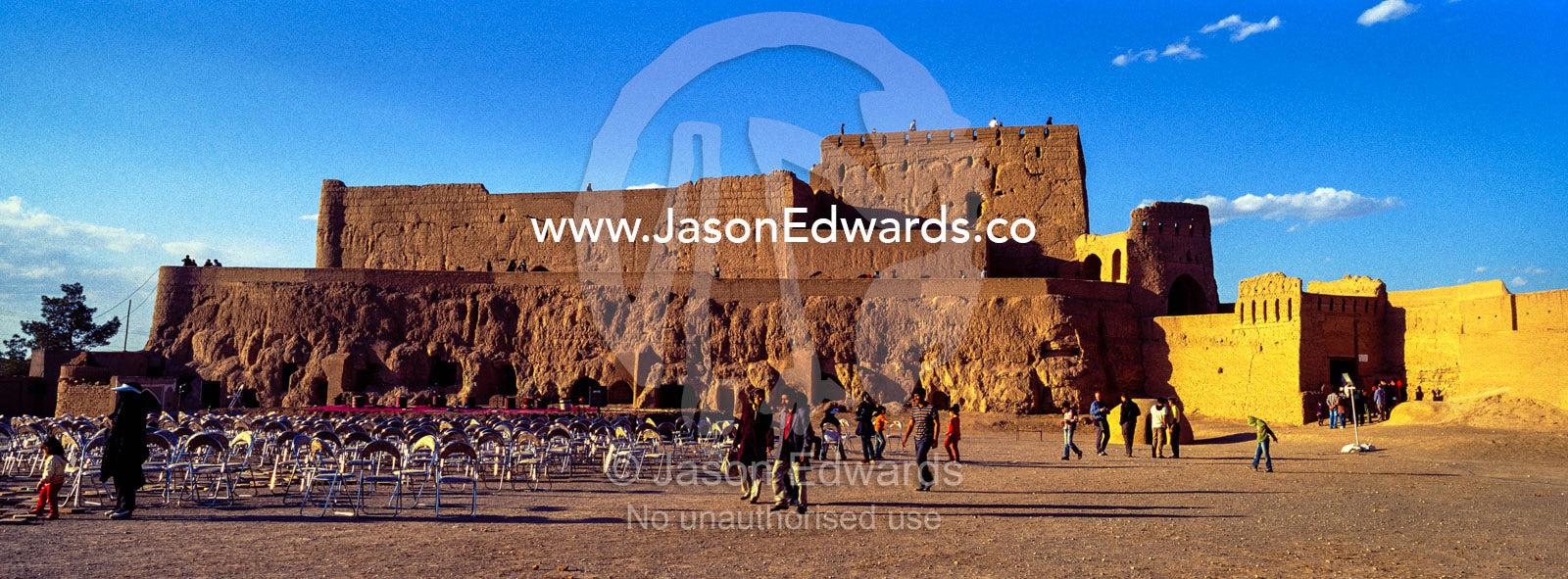 Plastic chairs for a presentation beneath the ramparts of a desert fortress. Narin Castle, Meybod, Meybod County, Yazd Province, Islamic Republic of Iran.