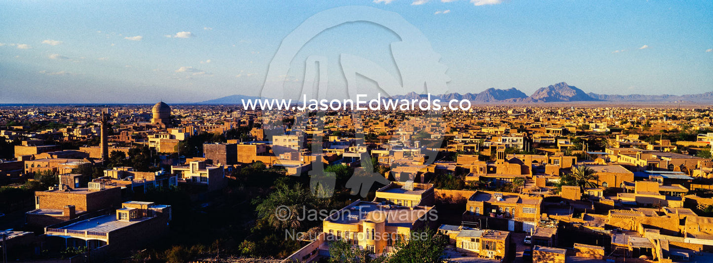 A minaret rises above an ancient city skyline to call people to prayer. Meybod, Meybod County, Yazd Province, Islamic Republic of Iran.