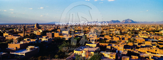 A minaret rises above an ancient city skyline to call people to prayer. Meybod, Meybod County, Yazd Province, Islamic Republic of Iran.