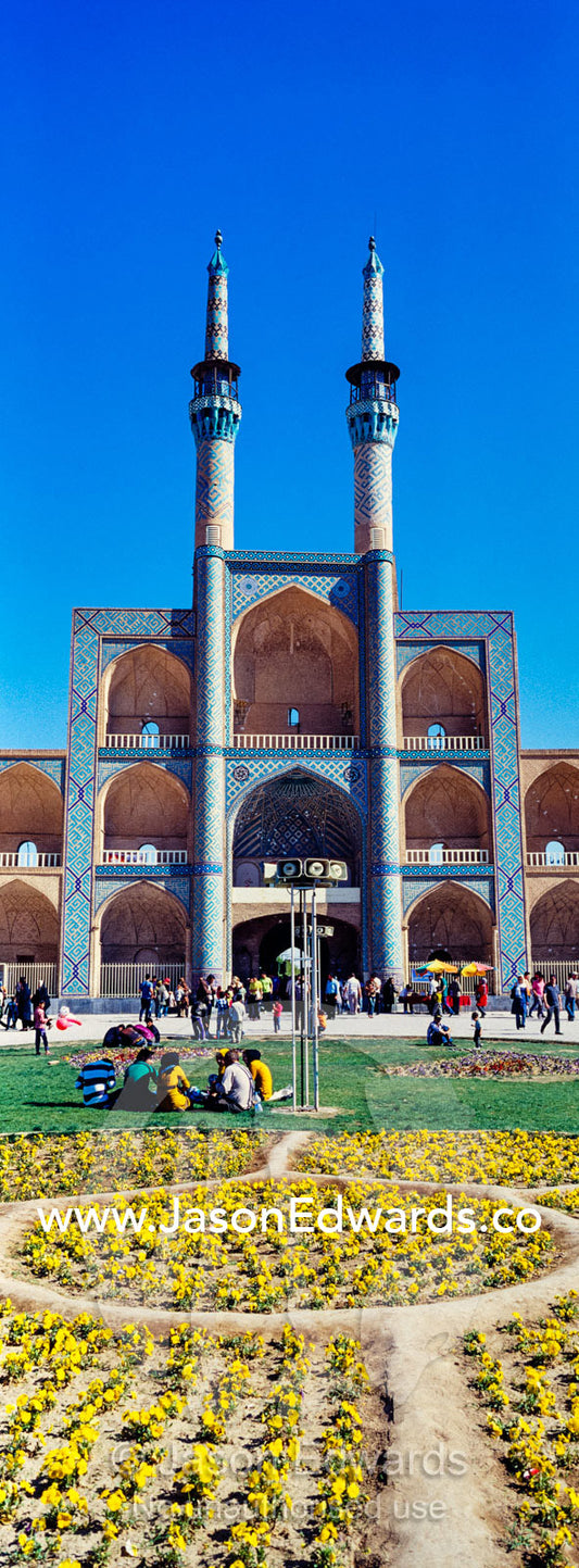 The towering minarets and iwans of Amir Chakhmaq Mosque overlook flower gardens in the square. Amir Chakhmaq Square, Yazd, Yazd Province, Islamic Republic of Iran.