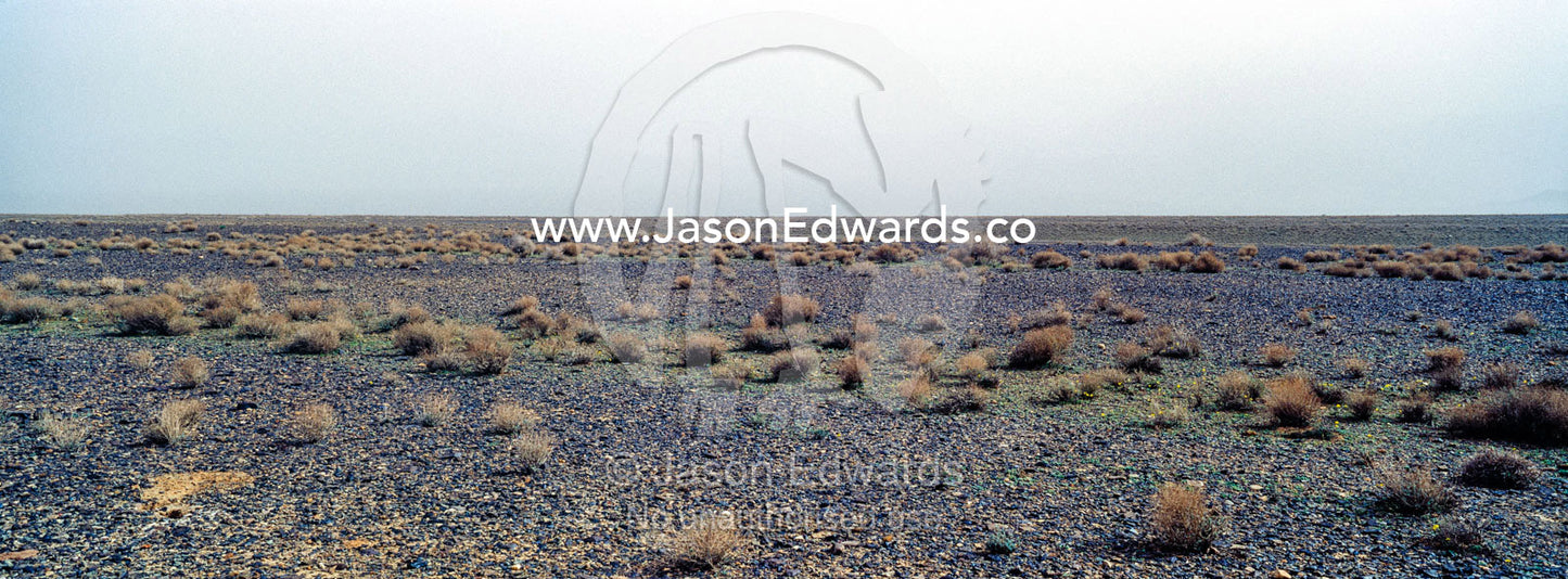 A misty morning over a barren gravel desert. Barzrud Rural District, Natanz County, Isfahan Province, Islamic Republic of Iran.