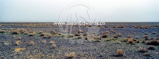 A misty morning over a barren gravel desert. Barzrud Rural District, Natanz County, Isfahan Province, Islamic Republic of Iran.