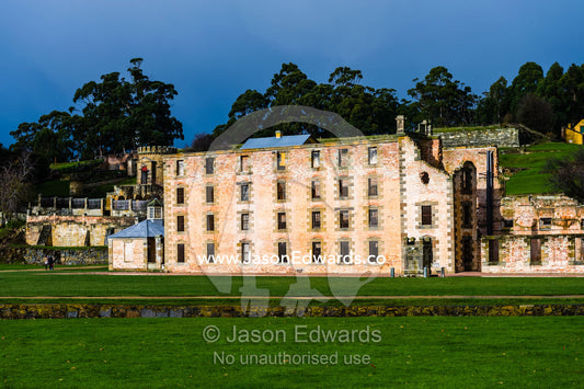 The facade and barred windows of the Port Arthur penitentiary overlooking a manicured lawn. Port Arthur Historic Site, Port Arthur, Tasmania,
Australia