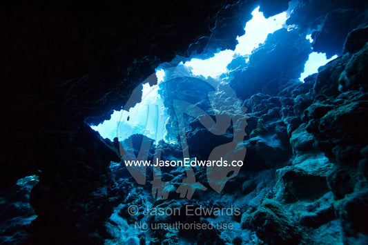 Sunlight for the ocean surface entering an underwater volcanic cave in a reef. Kokod Point, Ringgold Atolls, Pacific Ocean, Fiji Islands.