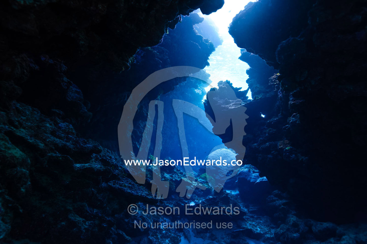 Sunlight for the ocean surface entering an underwater volcanic cave in a reef. Kokod Point, Ringgold Atolls, Pacific Ocean, Fiji Islands.