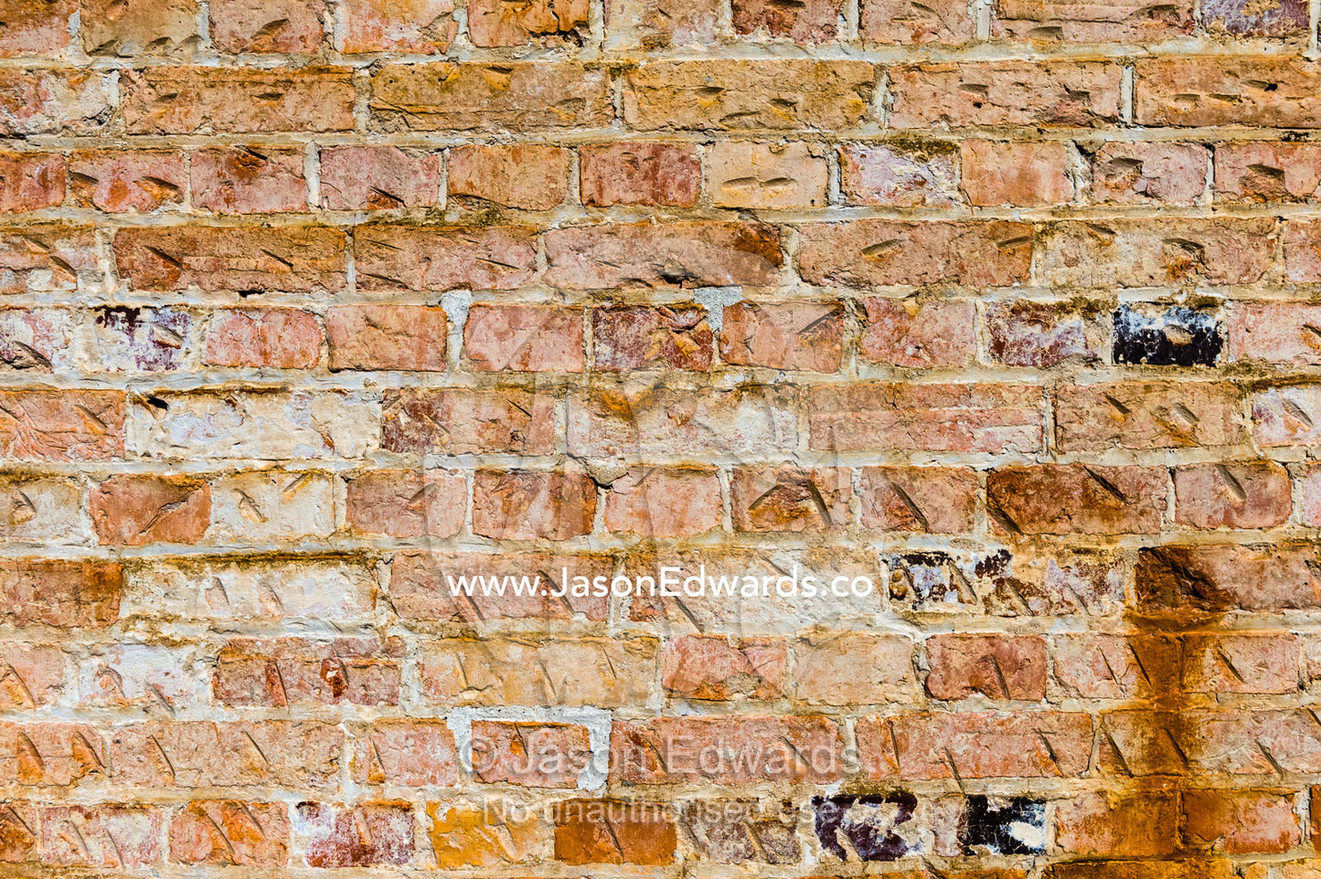 A textured wall of handmade bricks constructed by convicts. Port Arthur Historic Site, Port Arthur, Tasmania,
Australia.