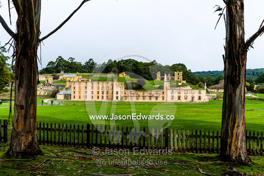 The facade and barred windows of the Port Arthur penitentiary overlooking a manicured lawn. Port Arthur Historic Site, Port Arthur, Tasmania,
Australia.