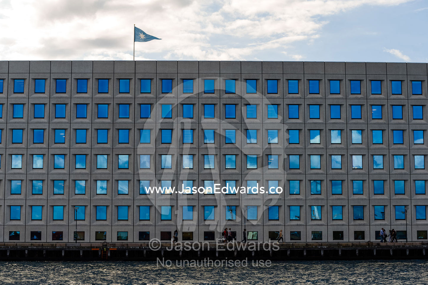 Cloud reflections in the opaque windows of an office block facade. Holmen, Copenhagen, Denmark.