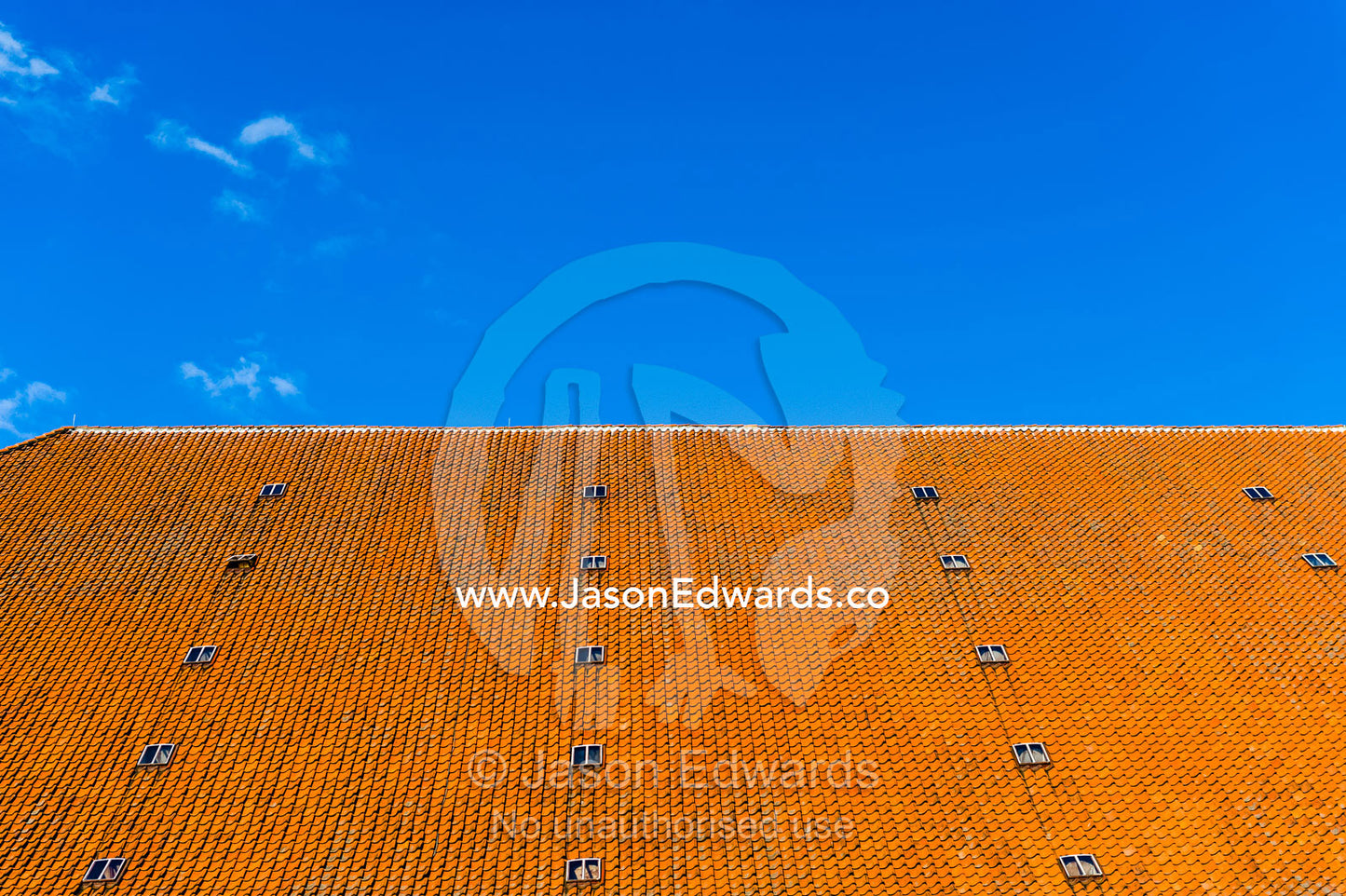 An orange tiled rooftop beneath a blue sky in Copenhagen. Bryghus Restaurant, Copenhagen, Denmark.