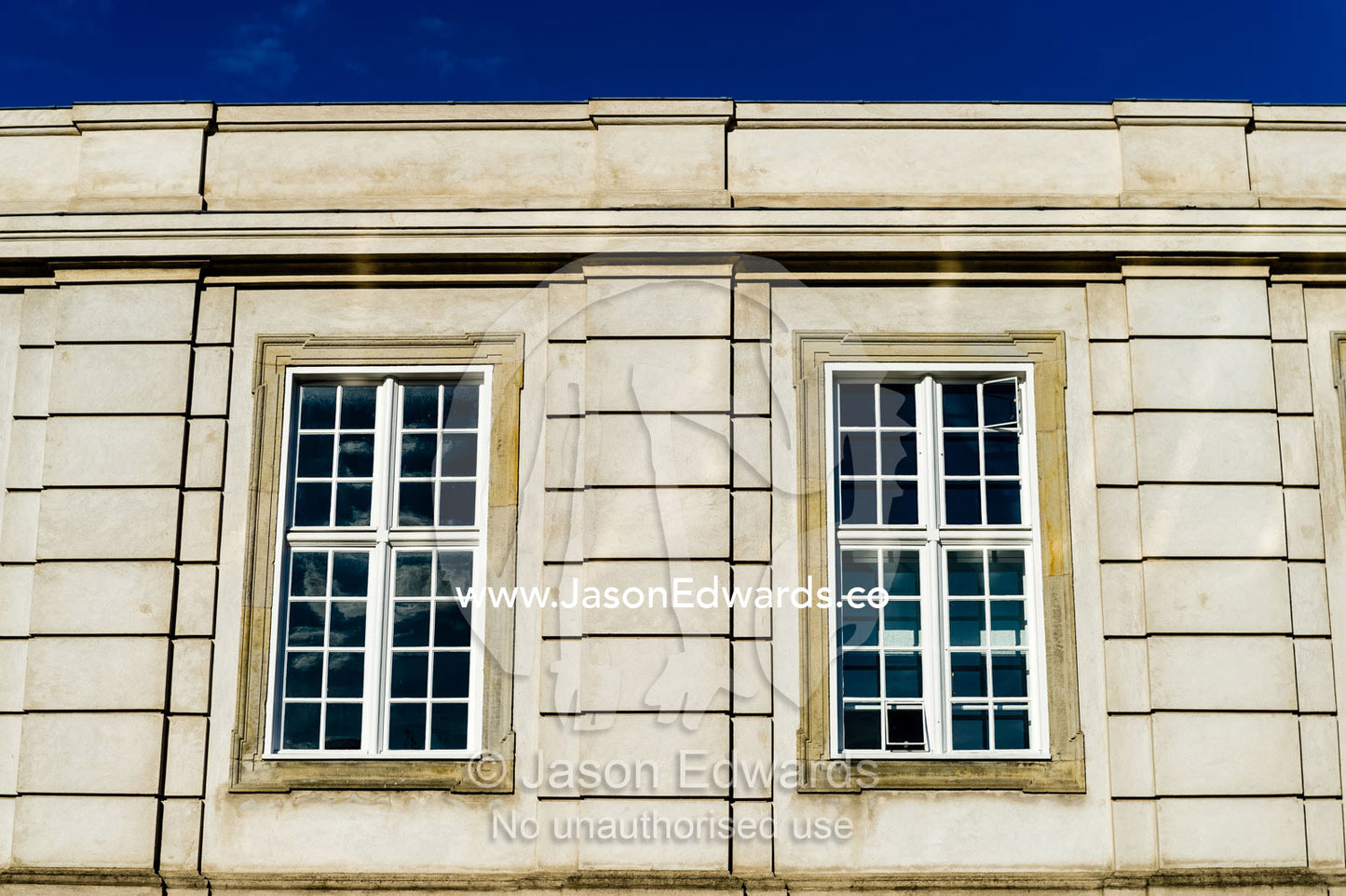 Pane glass windows overlook a canal from the Christiansborg Palace. Christiansborg Palace, Frederiksholms Canal, Copenhagen, Denmark.