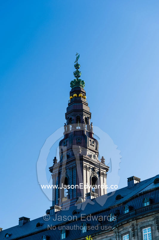 An ornate spire rises above the Christiansborg Palace. Christiansborg Palace, Copenhagen, Denmark.