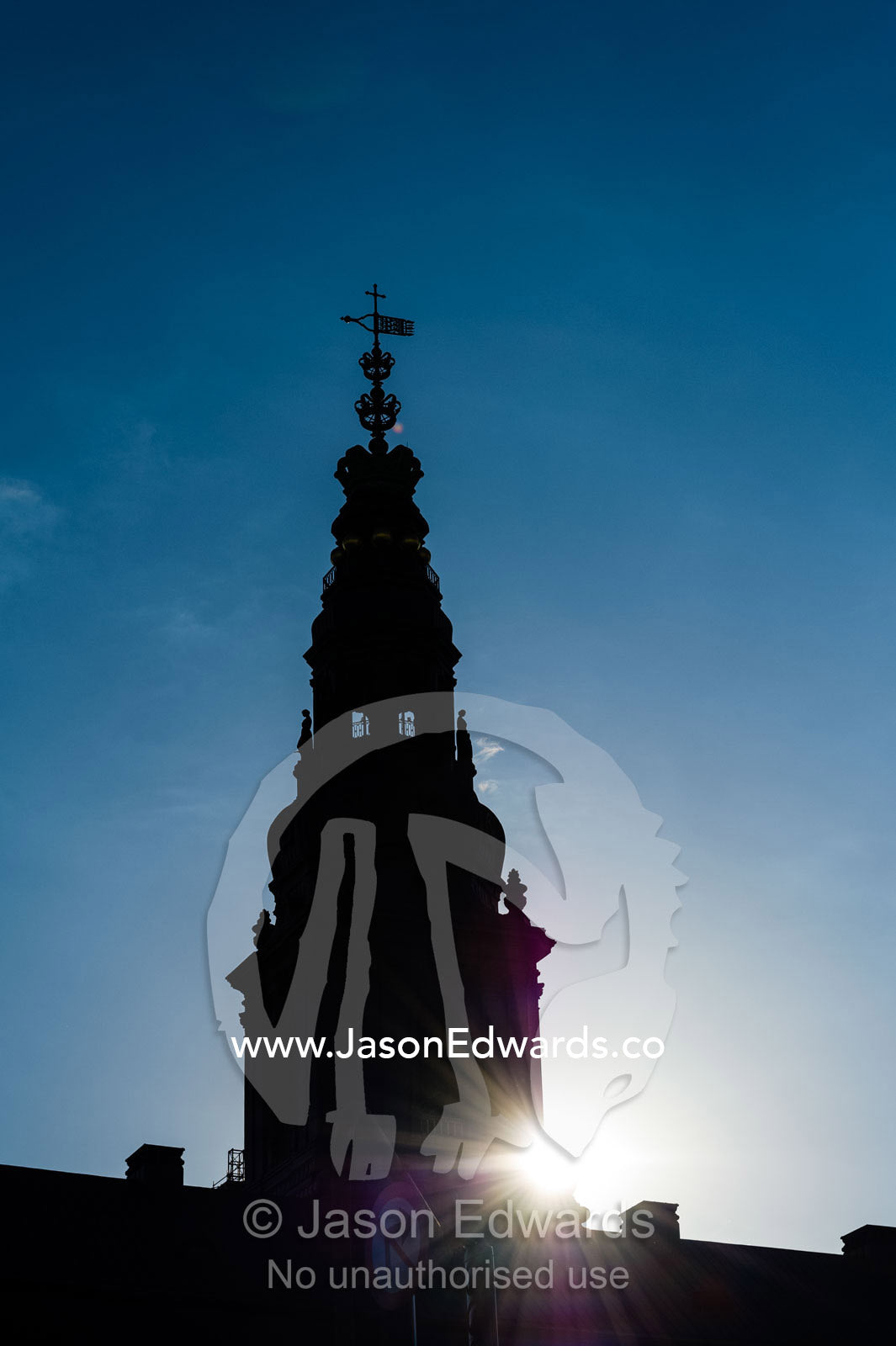 The silhouette of a spire on the Christiansborg Palace at sunset. Christiansborg Palace, Copenhagen, Denmark.