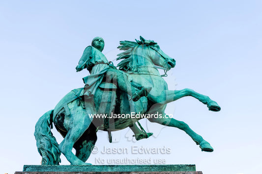 A bronze statue of a King riding a stallion. Amalienborg Square, Copenhagen, Denmark.