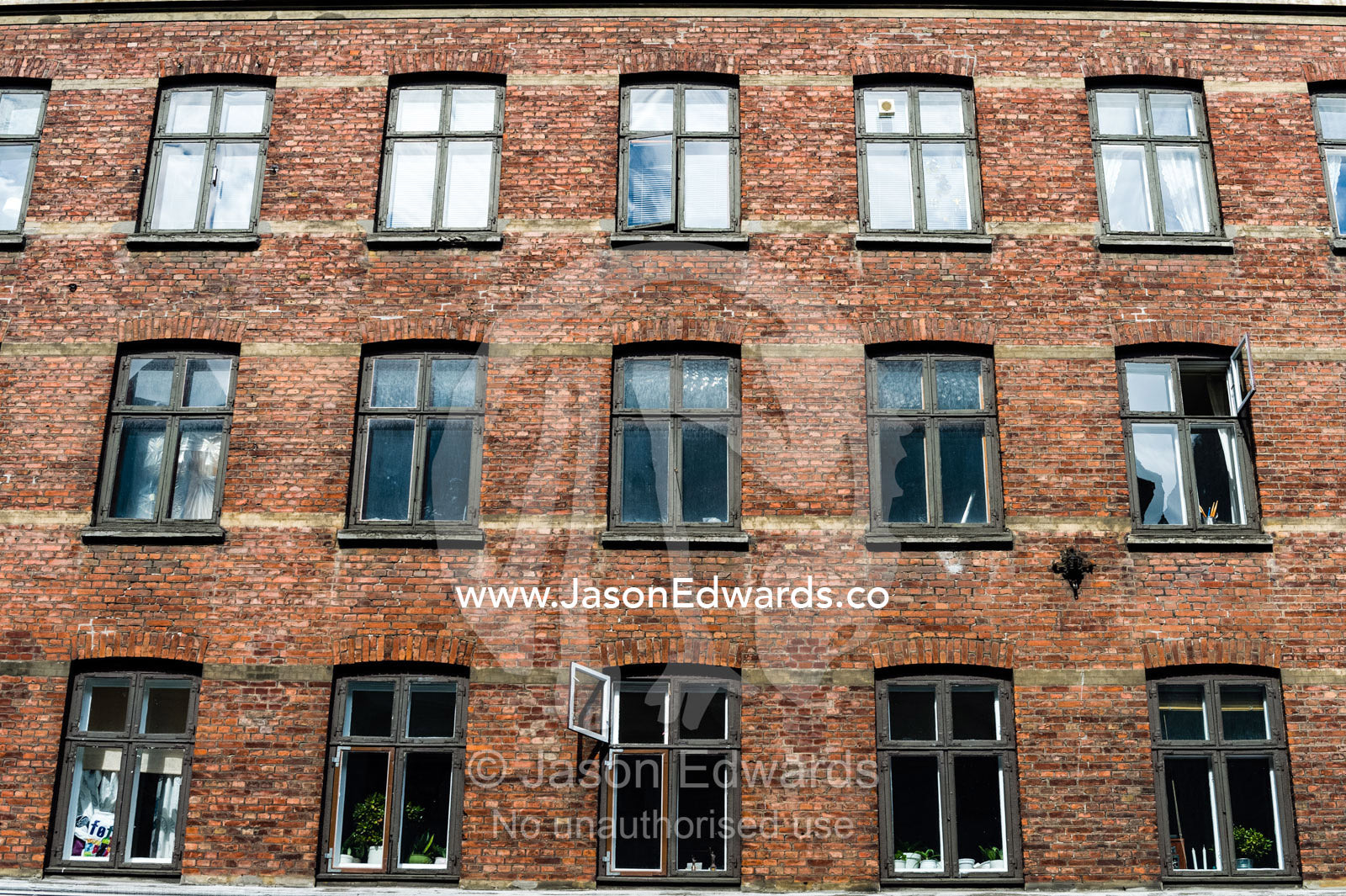 The facade and windows of a warehouse converted into apartments in Copenhagen. Copenhagen, Denmark.
